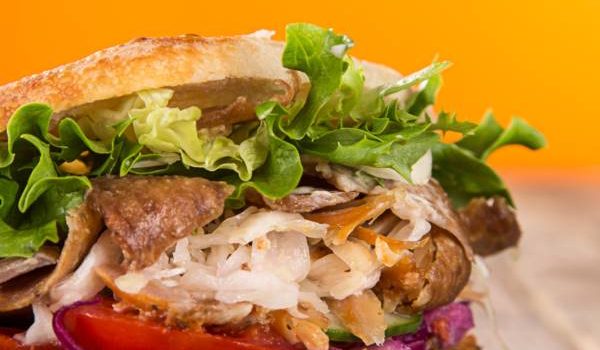 close up of kebab sandwich on wooden background