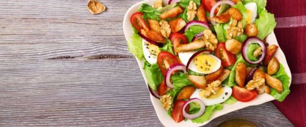 Delicious salad with chicken, nuts, egg and vegetables.