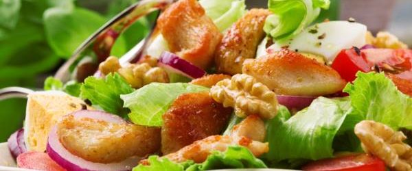 Delicious salad with chicken, nuts, egg and vegetables.